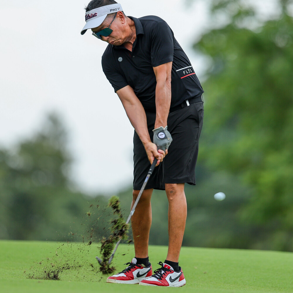 Rick at impact, divot in the air